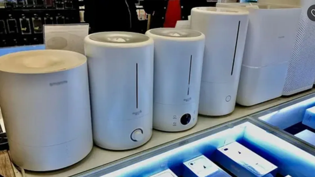 White humidifiers lined up on a retail shelf